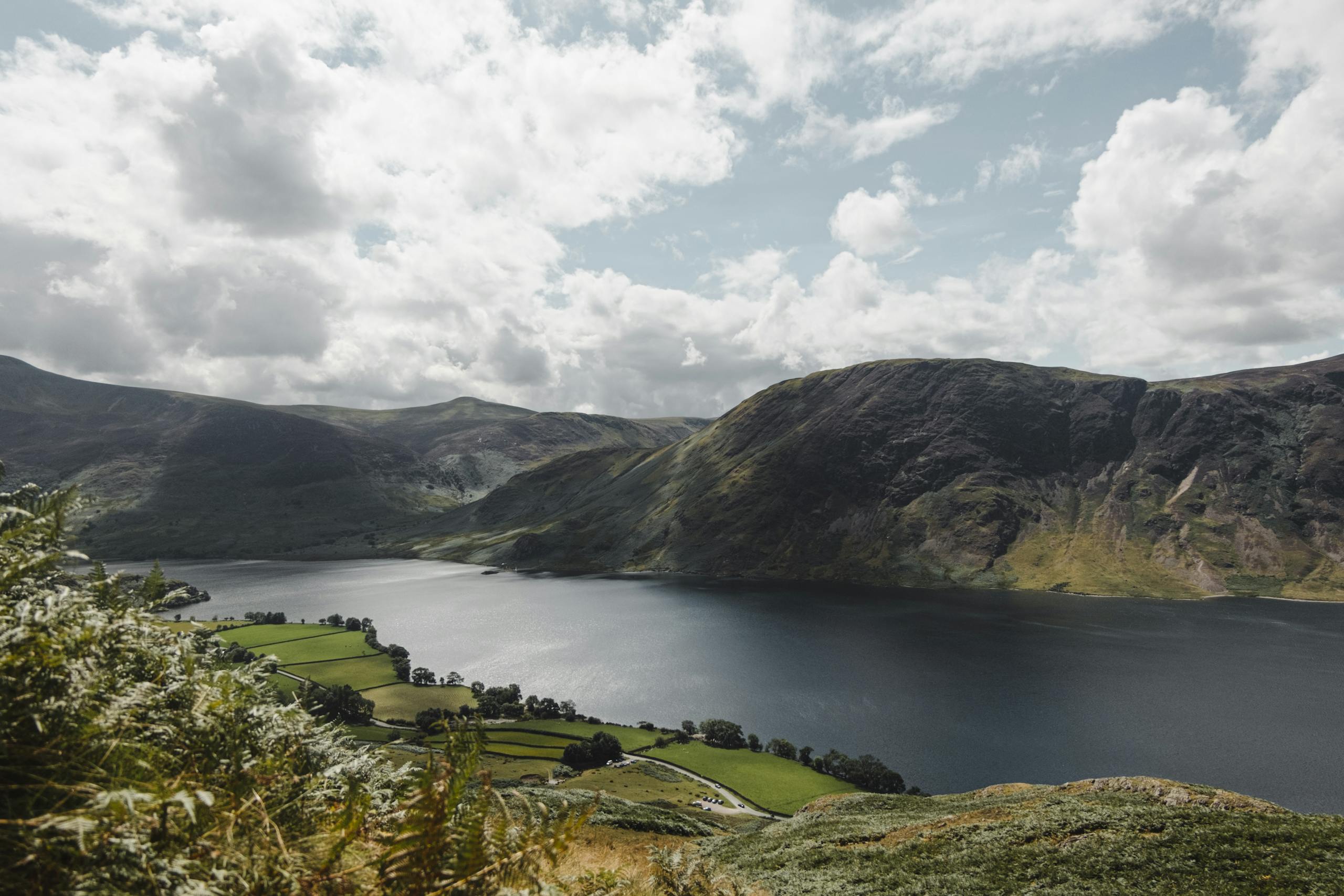 Picturesque view of the Lake District's rolling hills and serene water.