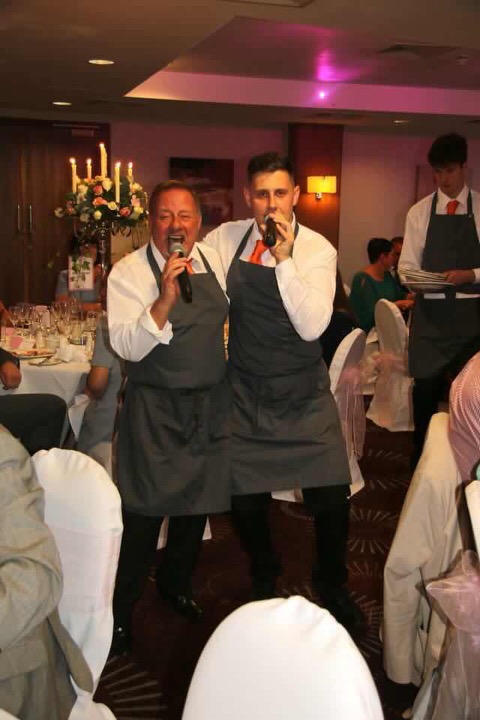 Singers in Disguise's two singing waiters entertaining the guests at a show in southport